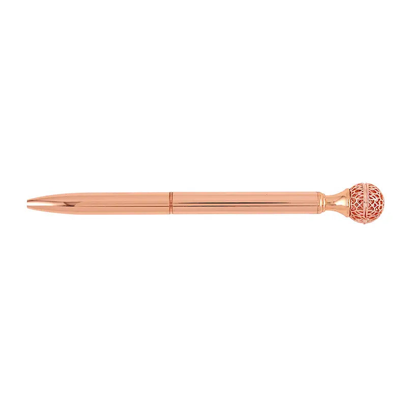 Rose gold pen with decorative cap on a white background