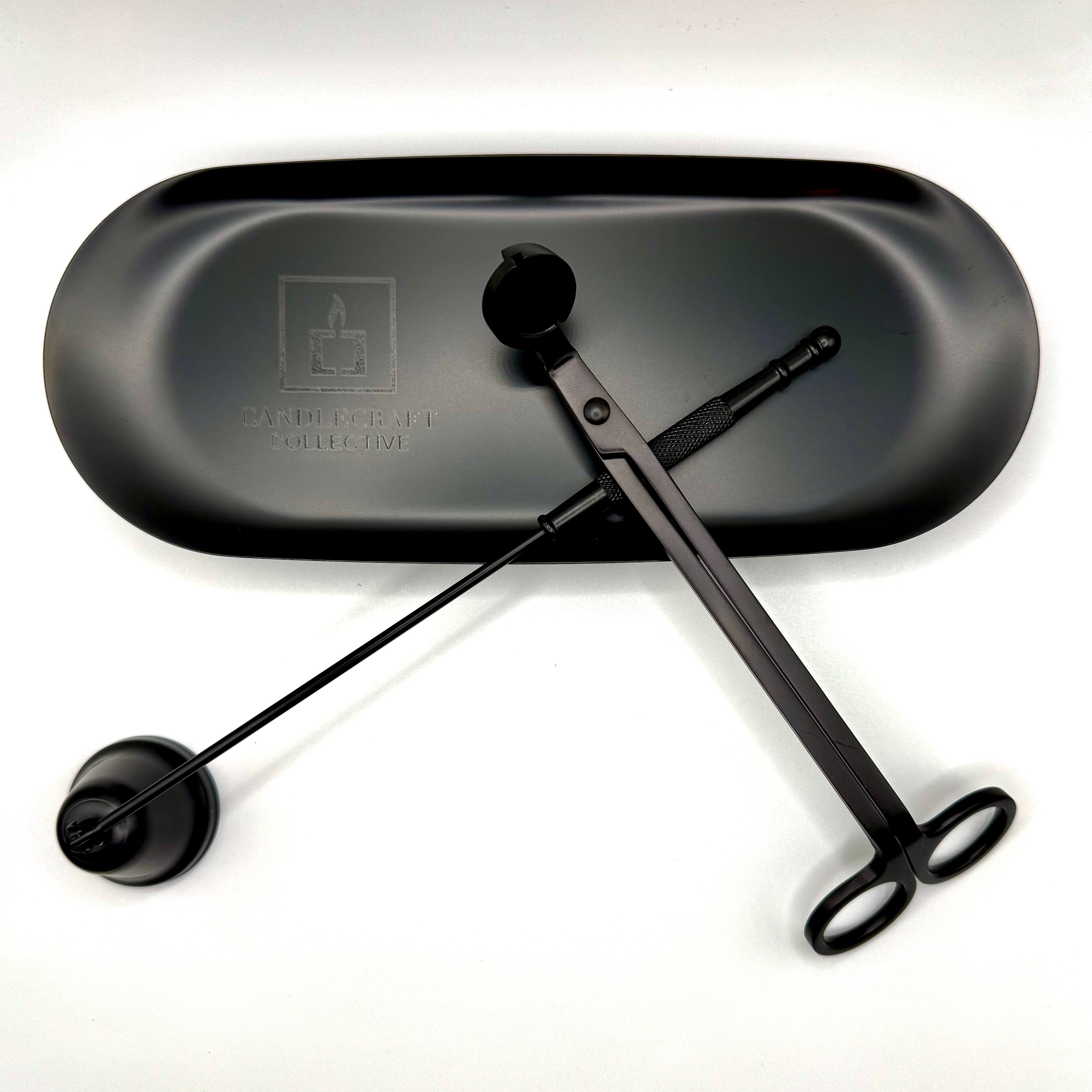 Black metal tool with a black tray on a white background